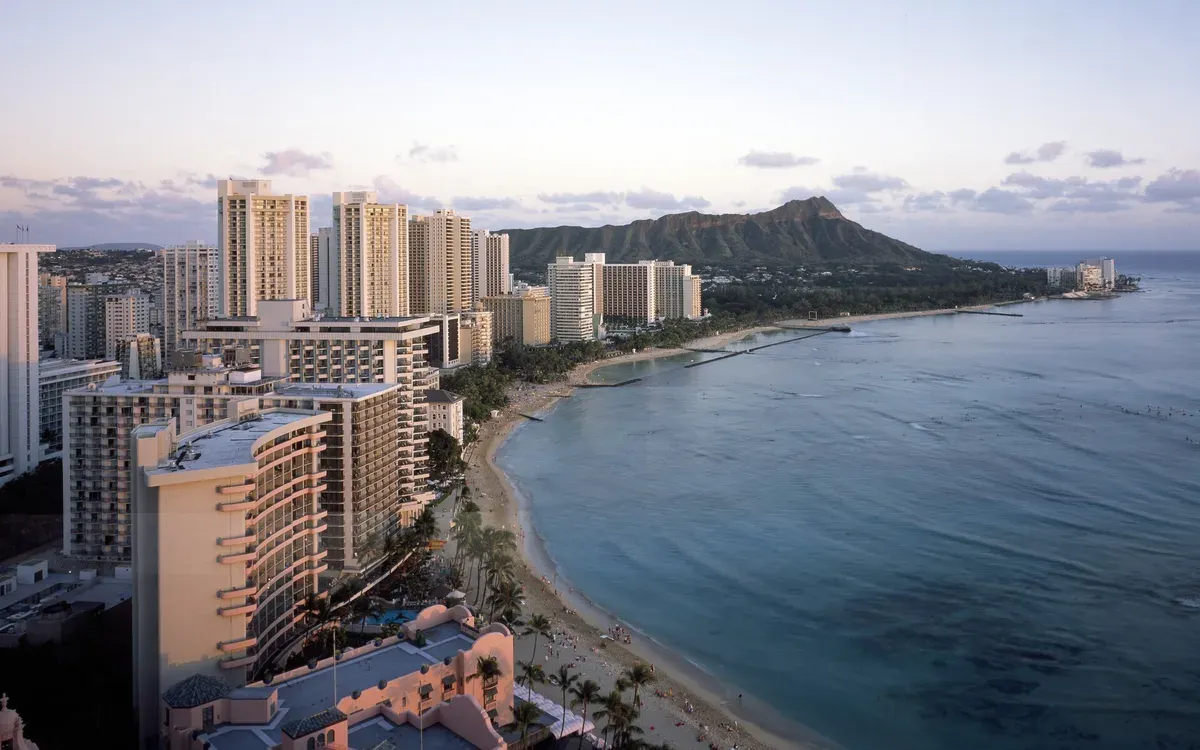 Waikiki Beach curving toward Diamond Head in Honolulu at dusk