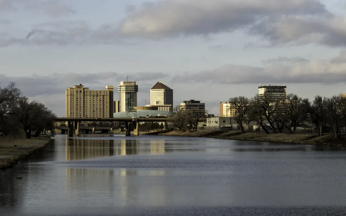 The downtown Wichita skyline reflected in the Arkansas River in late-afternoon light