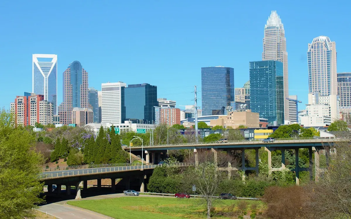 The Charlotte, North Carolina uptown skyline rising above a highway interchange on a clear day