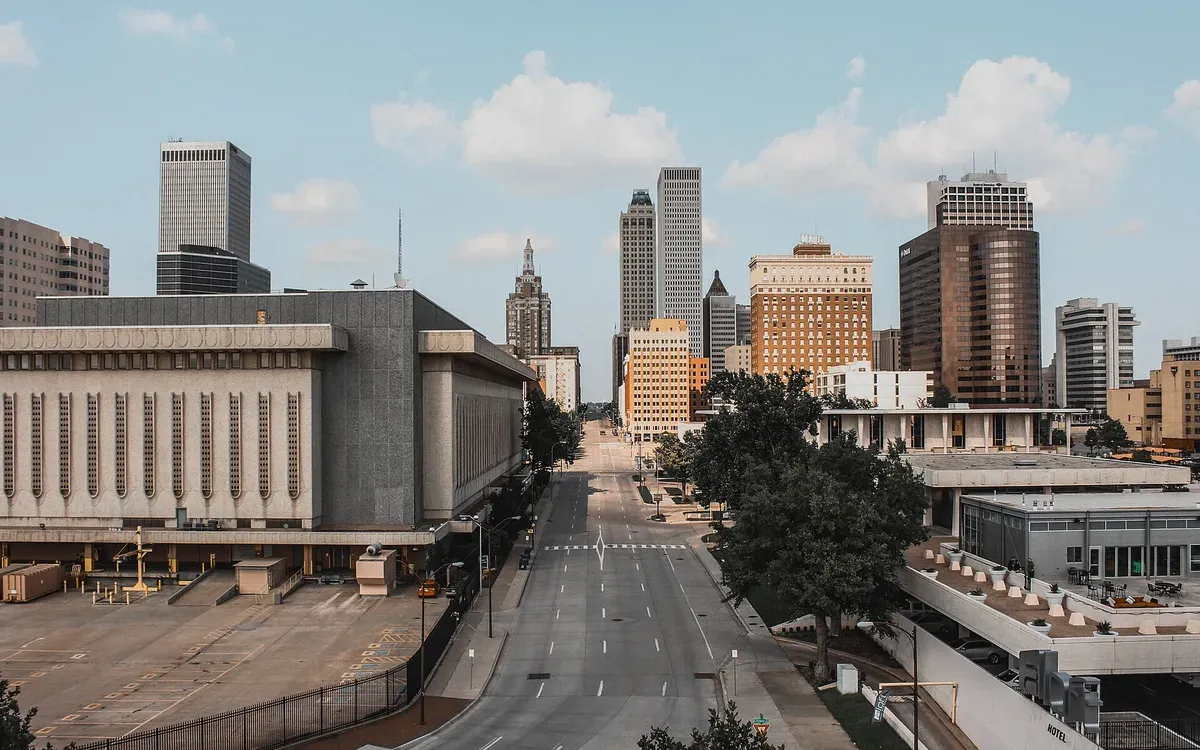 The downtown Tulsa skyline against a clear sky, seen from the Cox Business Center parking garage