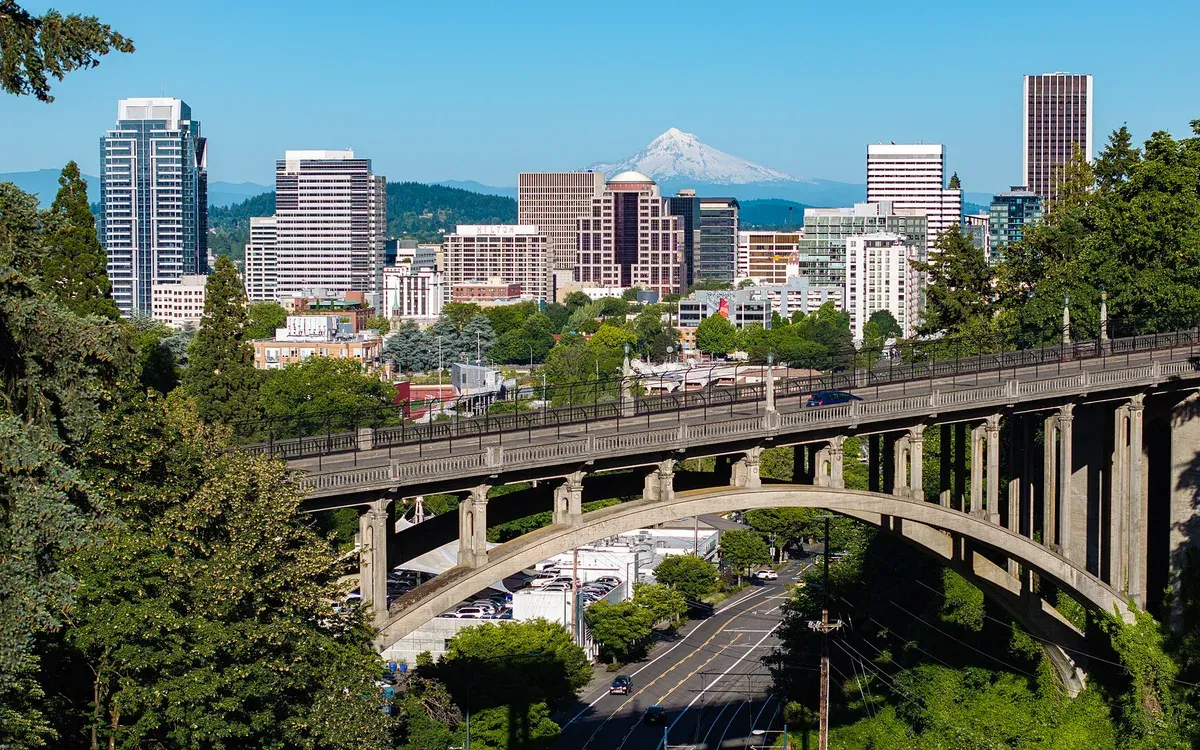 An aerial view of downtown Portland, Oregon with Mt. Hood visible on the horizon